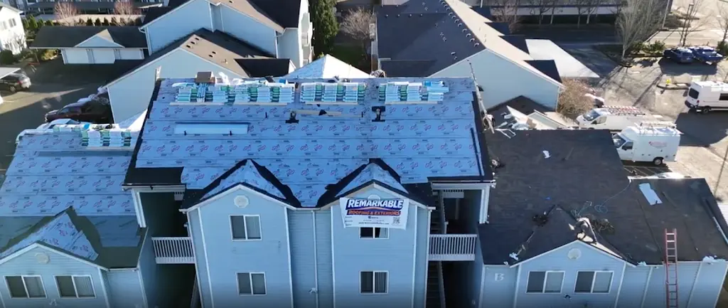 Remarkable Roofing crew installing a multi-family roof
